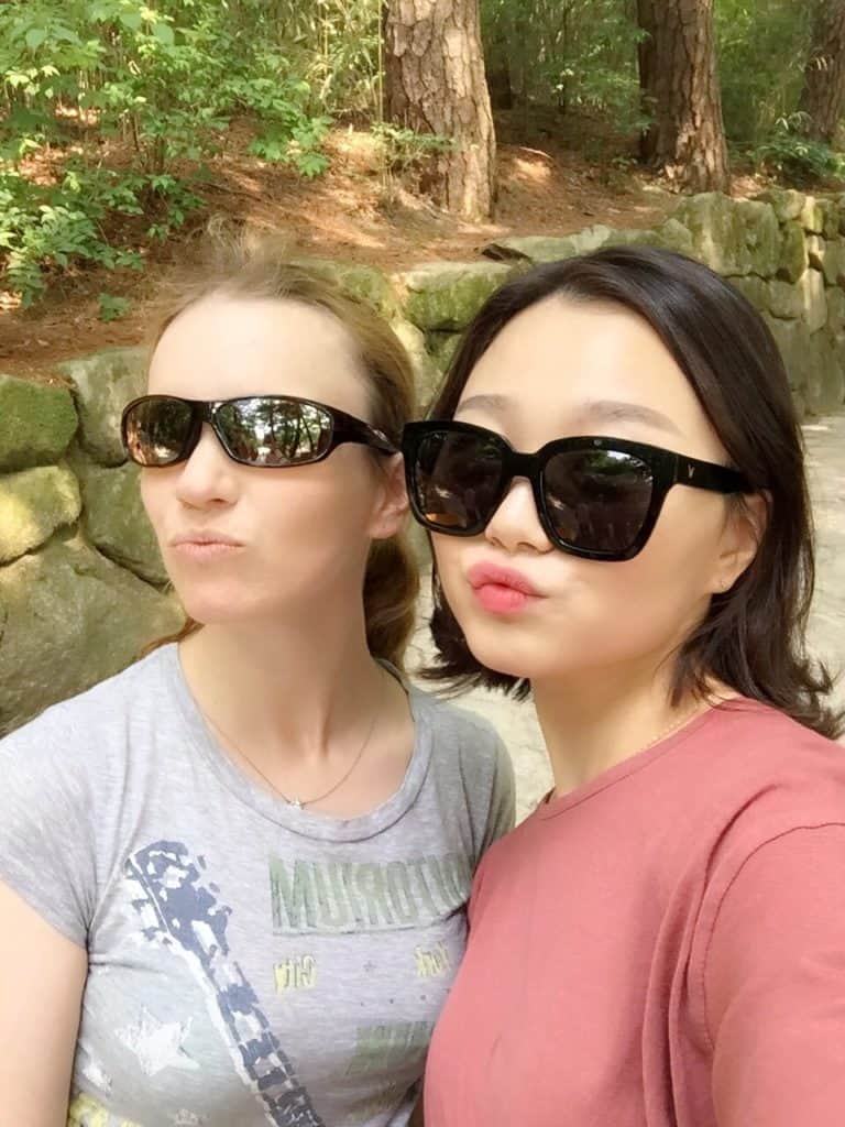 A seflie of two young girls while hiking.