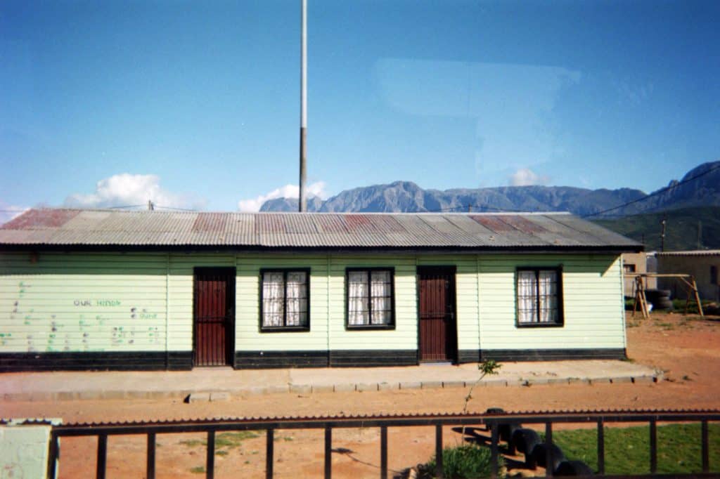 South African house with mountains towering behind. 