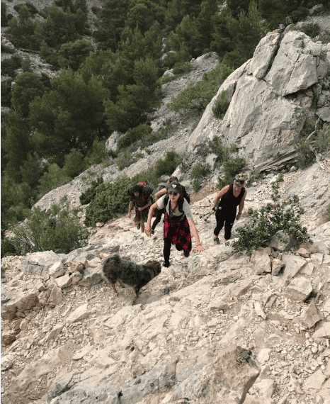 Tourists hiking up a mountain located in the Parc National des Calanques in France